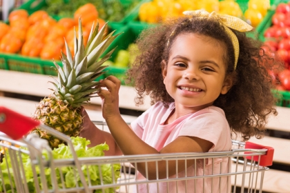 Small child holding produce